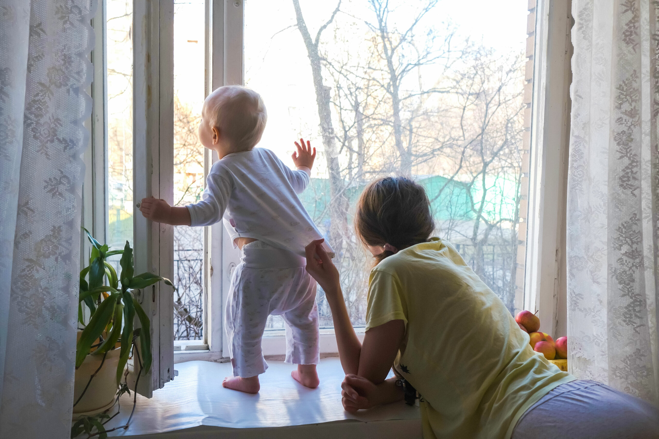 mom and baby enjoying an open window